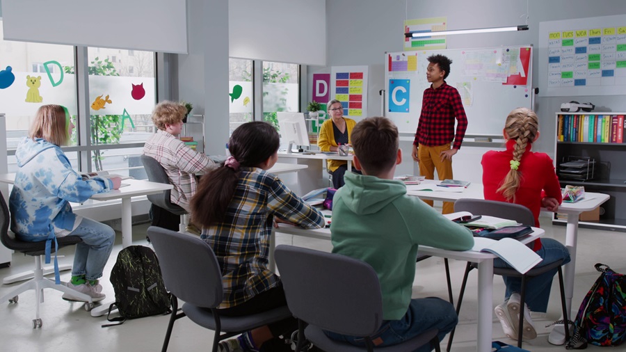 Multiethnic classmates listen to there classmate reporting