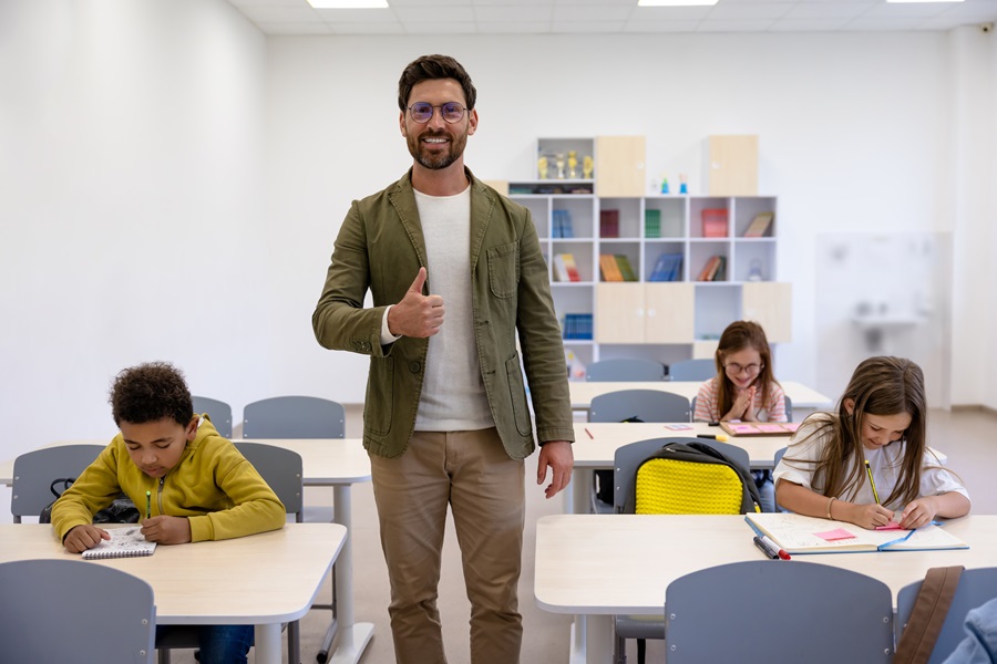 Kids writing a test and teacher 