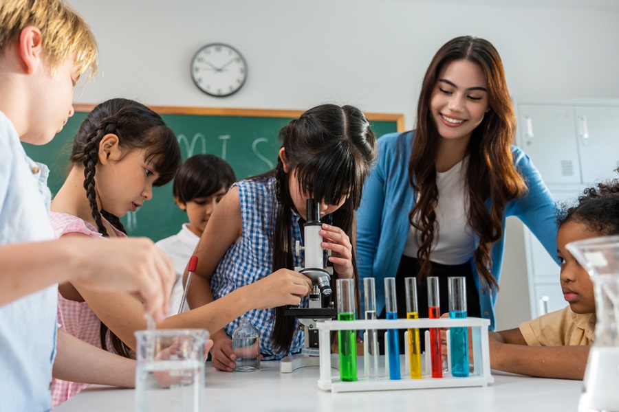 Adorable student learn with teacher in classroom 