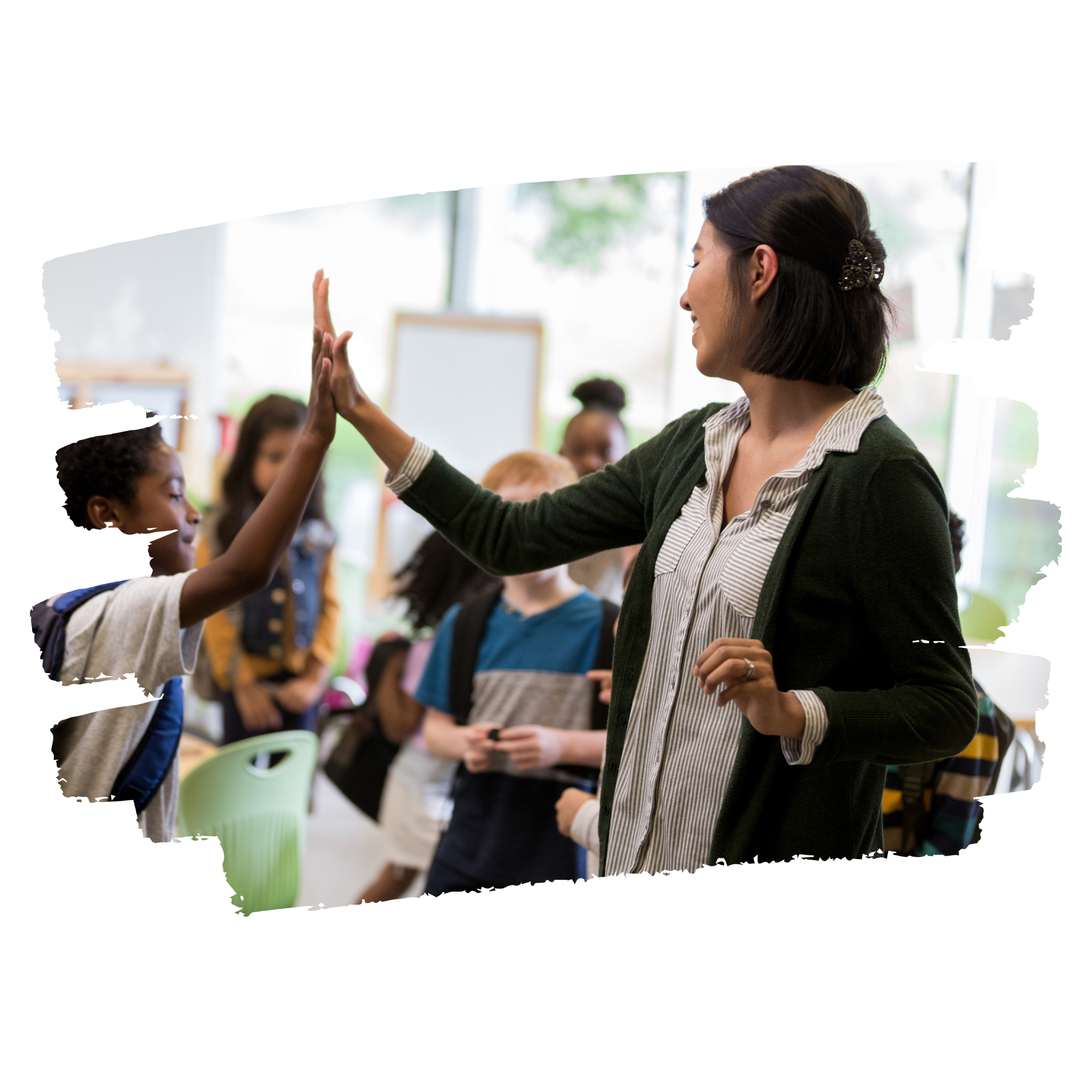 Teacher high fives young student with classroom in the background.