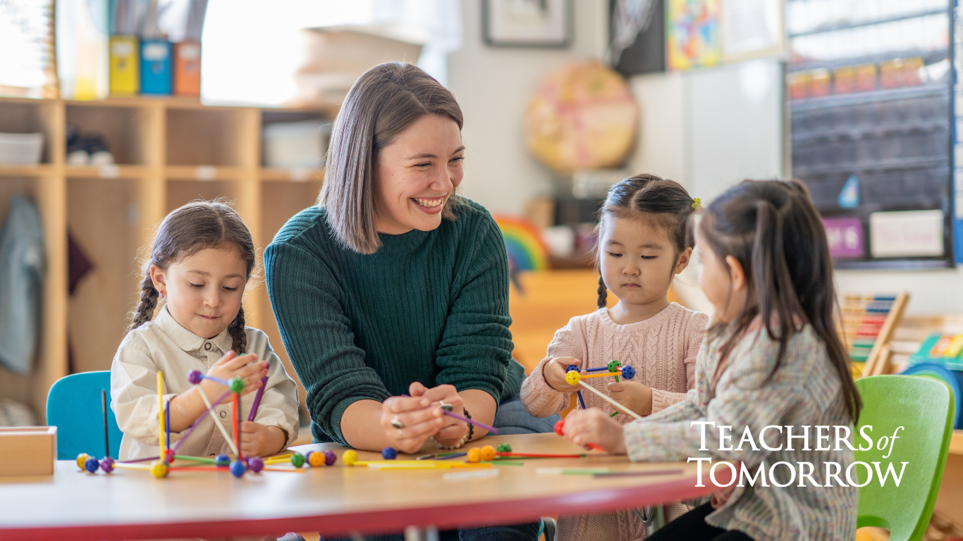 a teacher working with a group of children at a table