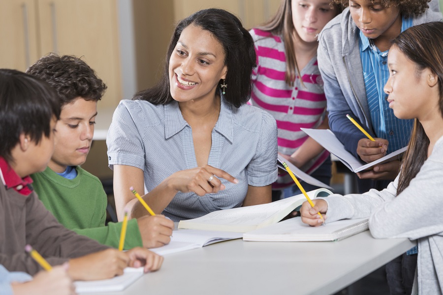 Teacher helping students in classroom